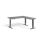 Lavoro Advance Corner triple-motor standing desk, dark grey frame and graphite desktop; pictured size representative