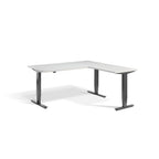 Lavoro Advance Corner triple-motor standing desk, dark grey frame and light grey desktop; pictured size representative