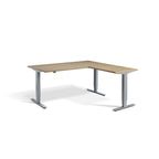 Lavoro Advance Corner triple-motor standing desk, silver frame and natural oak desktop; pictured size representative