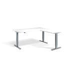 Lavoro Advance Corner triple-motor standing desk, silver frame and white desktop; pictured size representative