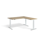 Lavoro Advance Corner triple-motor standing desk, white frame and natural oak desktop; pictured size representative